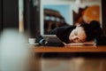 Lifestyle freelance woman he has resting sleeping after hard work long time in coffee shop Royalty Free Stock Photo