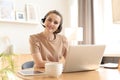Freelance operator talking with headsets and consulting clients from home office Royalty Free Stock Photo