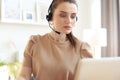 Freelance operator talking with headsets and consulting clients from home office Royalty Free Stock Photo