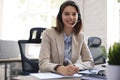 Freelance operator talking with headsets and consulting clients from office Royalty Free Stock Photo