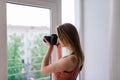 Freelance photographer woman with camera at home office editing photos on a computer Royalty Free Stock Photo