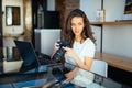 Freelance photographer woman with camera at home office editing photos on laptop Royalty Free Stock Photo