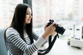 Freelance photographer young woman at home office editing photos, empty camera screen Royalty Free Stock Photo