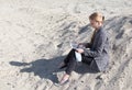 freelance and remote work.business woman in stylish business suit with laptop sitting in desert sand. Female student
