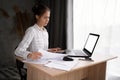 Freelance young hispanic businesswoman using laptop working at home. Working from home, remotely work, self isolation Royalty Free Stock Photo