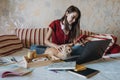 Freelance young woman working in home office with laptop computer and cat. Remote online working, Flexible workspace and Royalty Free Stock Photo