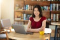 Freelancer Asian Girl Smiling At Camera While Working On Laptop In Cafe Royalty Free Stock Photo