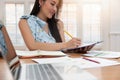 Freelancer business woman holding pen while working with business chart in cafe