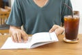 A freelancer checking schedule and drinking ice coffee. Royalty Free Stock Photo