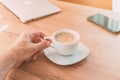 Freelancer drinking coffee at home office before getting to work