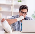 Freelancer with foot injury working from home Royalty Free Stock Photo