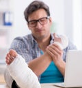 Freelancer with foot injury working from home Royalty Free Stock Photo