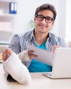 Freelancer with foot injury working from home Royalty Free Stock Photo