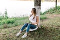 Freelancer girl working with laptop outdoors near water