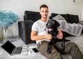 Freelancer guy sitting at home working in laptop and with dog in Royalty Free Stock Photo