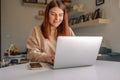 Freelancer lifestyle. Remote job. Virtual office. Image of young cheery happy positive cute beautiful business woman sit Royalty Free Stock Photo