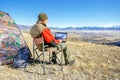 Freelancer man working on freelance on netbook during vacation holidays in autumn Royalty Free Stock Photo