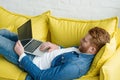 Freelancer man working on laptop while lying