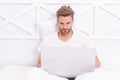 Freelancer man working or shopping online on laptop in bedroom bed Royalty Free Stock Photo