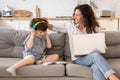 Freelancer mother help preschool son to put on headphones for homework at elementary online school Royalty Free Stock Photo