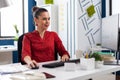 Freelancer in office sitting at desk typing on computer keyboard