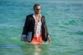 Freelancer on summer sea beach. business man refreshing after working day. business vacation. handsome business man on Royalty Free Stock Photo