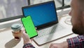 Freelancer swipes and types on green chromakey smartphone