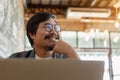 Freelancer is thinking idea or trying to solve a problem at cafe. A man is working on his laptop at cafe. Royalty Free Stock Photo