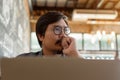 Freelancer is thinking idea or trying to solve a problem at cafe. A man is working on his laptop at cafe. Royalty Free Stock Photo