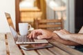 Freelancer using laptop computer on balcony in morning, work from home concept