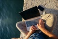 Freelancer using laptop network on beach