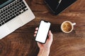 Freelancer using mobile phone with blank white mockup screen at office desk Royalty Free Stock Photo