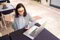 Freelancer using smartphone and laptop sitting outdoor cafe drink water Royalty Free Stock Photo