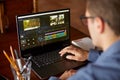 Freelancer video editor works at the laptop computer with movie editing sofware. Videographer vlogger or blogger camera