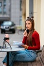 Freelancer woman in a summer cafe doing remote work. Royalty Free Stock Photo