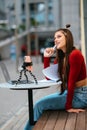 Freelancer woman in a summer cafe doing remote work. Royalty Free Stock Photo