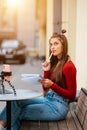 Freelancer woman in a summer cafe doing remote work. Royalty Free Stock Photo