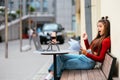 Freelancer woman in a summer cafe doing remote work. Royalty Free Stock Photo