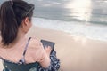 Freelancer Woman is Working on Tablet While Travel Vacation Trip at The Beach, Smart Woman is Using Tablet for Communication and Royalty Free Stock Photo