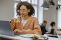 A freelancer worker uses a laptop on a table with a cup of coffee