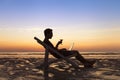 Freelancer working with laptop on the beach