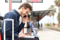 Freelancer working with a laptop and phone in a train station Royalty Free Stock Photo