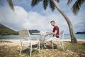 Freelancer working on laptop from tropical destination Royalty Free Stock Photo