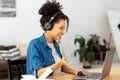 Freelancer working remotely discussion something Happy woman young female student using a laptop Royalty Free Stock Photo