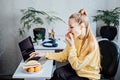 Freelancer young woman eating healthy food when working from home. Woman eating Healthy Grain Snacks and fruits while Royalty Free Stock Photo