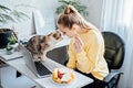 Freelancer young woman eating healthy food when working from home. Woman eating Healthy Grain Snacks and fruits while Royalty Free Stock Photo