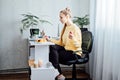 Freelancer young woman eating healthy food when working from home. Woman eating Healthy Grain Snacks and fruits while Royalty Free Stock Photo