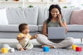 Black Woman Working On Laptop And Taking Care Of Her Infant Child Royalty Free Stock Photo