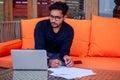 Freelancing and remote work.handsome male student working laptop keyboard sitting in cafe on the beach with free Royalty Free Stock Photo