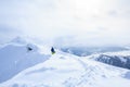 Freeride backcountry snowboarder on the trail on mountain ridge covered with snow powder